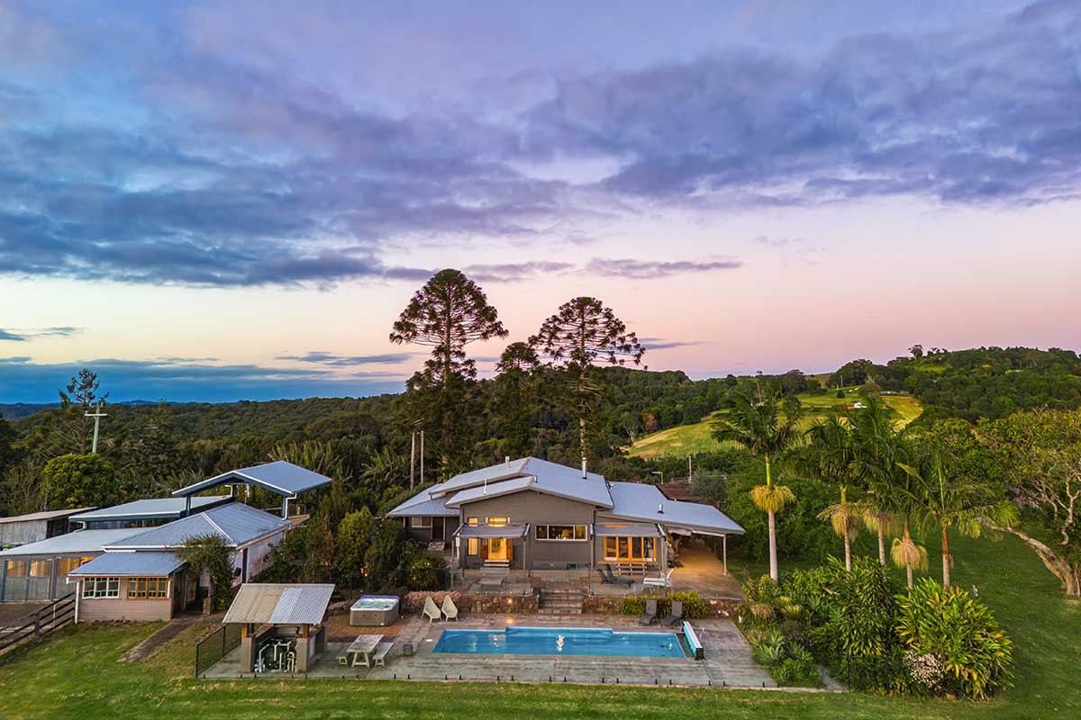 Cromwell Farm House A grey house with a pool in the middle of a field Byron Bay