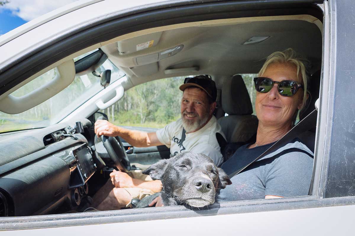 Greg and Alison Cromwell in a car with their dog heading to Ulmarra pet-friendly accommodation