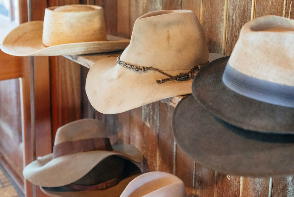 Brimmed hats on a shelf at Gelnugie Station as part of the holiday pack list