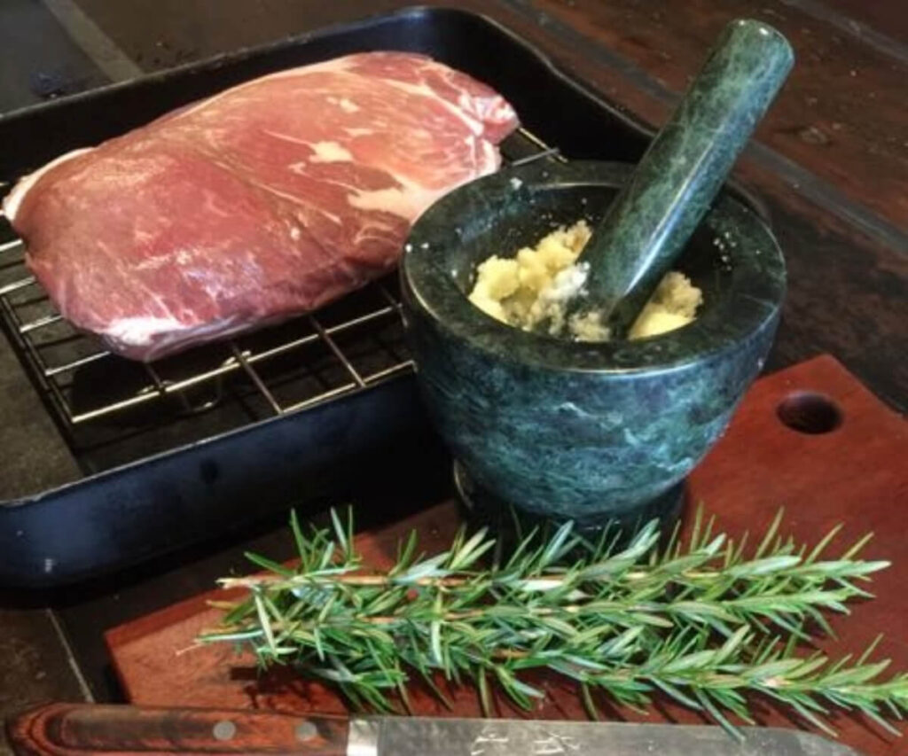 Cromwell Farms Pork Collar Butt with mortar and pestle and fresh rosemary