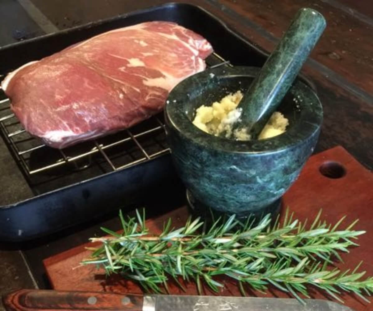 Cromwell Farms Pork Collar Butt with mortar and pestle and fresh rosemary